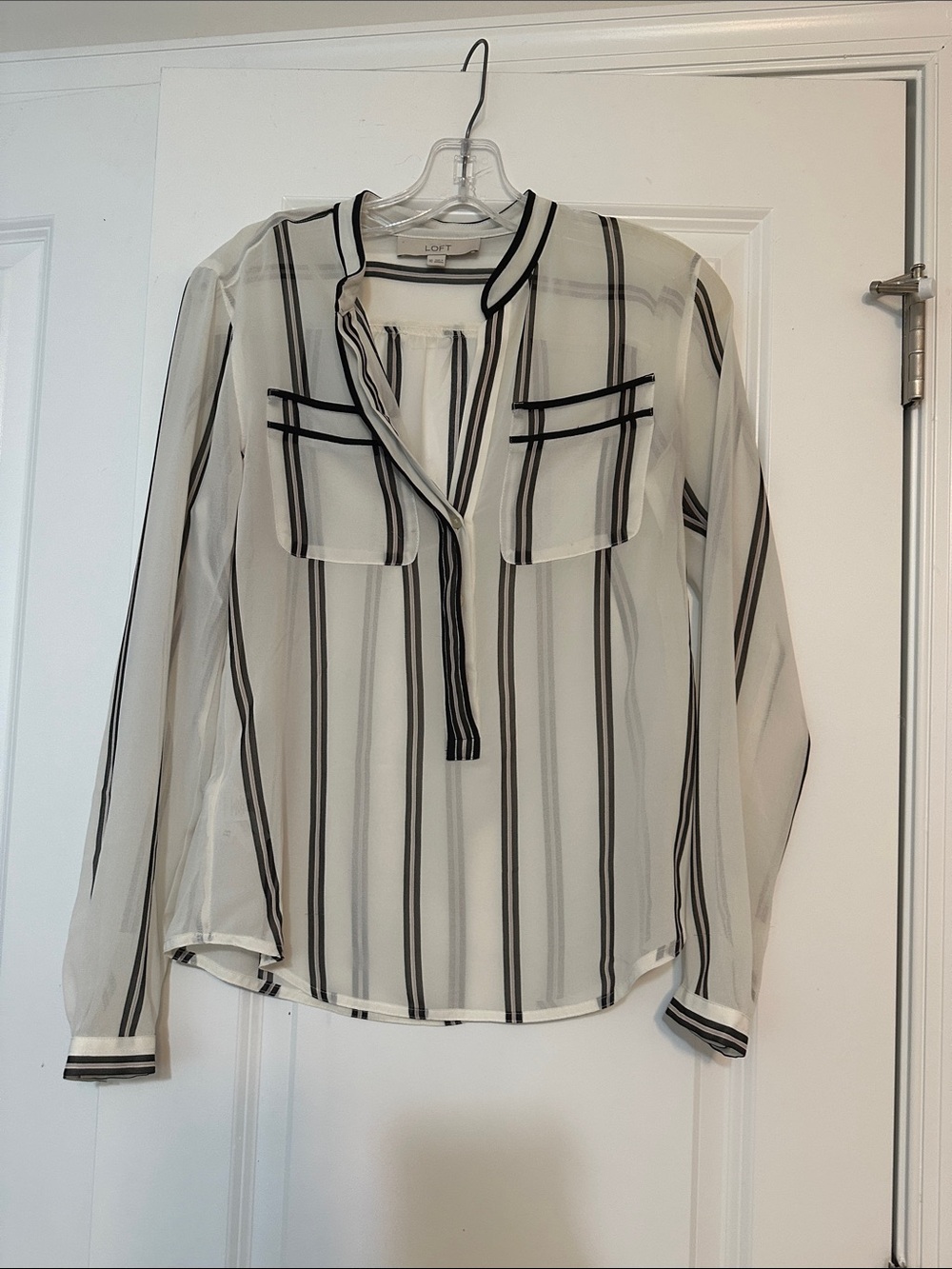 Sz XS Loft blouse features a sheer, striped design with a v-neck and pockets.